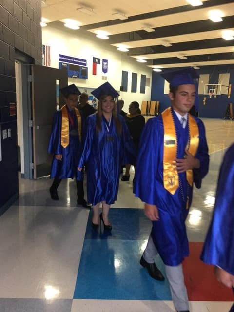 Graduates processing into the gym.