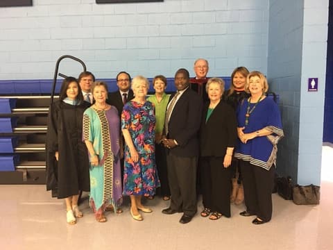 Faculty, staff and guests together in the gym on graduation day, around 2017.