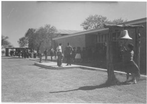 Eunice ringing the dining hall bell; alumni remember the cinnamon rolls on Wednesdays.