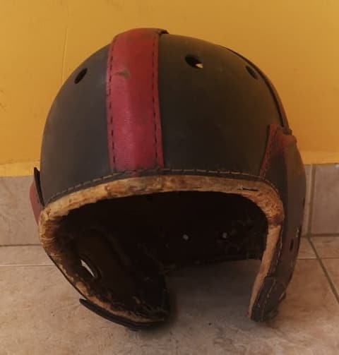 The Tex-Mex-era leather football helmet, three-quarter view.