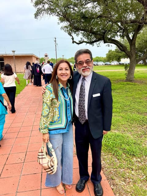 Two alumni reunited on the campus walkway after many years — “Viva Pan Am!”.