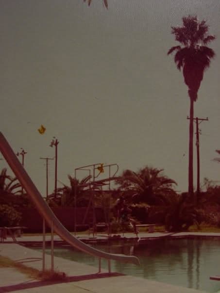 The school pool and its slide, 1978; a classmate remembers the big toads that came out around it.