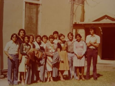 A group of students outside a church on a trip.