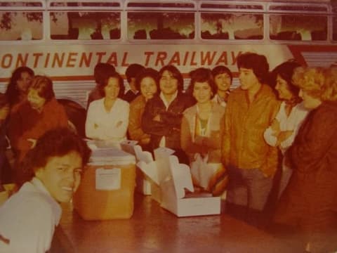 The choir boarding a Continental Trailways bus for its tour, with coolers and boxes of food.