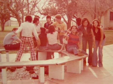 Students around the benches outside, one in the famous plaid pants the commenters tease about.