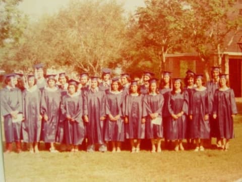 The Class of 1978 in caps and gowns on the lawn.