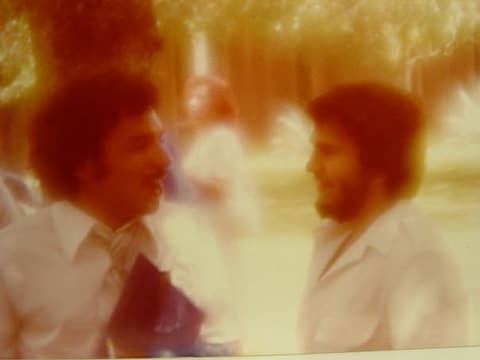Two friends talking on graduation day.