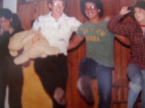 Students performing a skit on a stage with wood-panelled walls, September 1977.