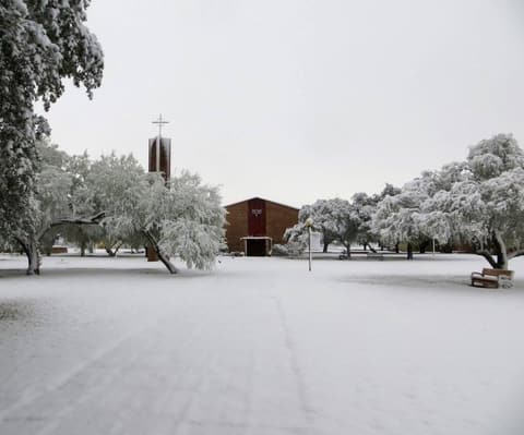 Snow on the walkway to the chapel, December 8, 2017 — one of the few times it has snowed at Pan Am.