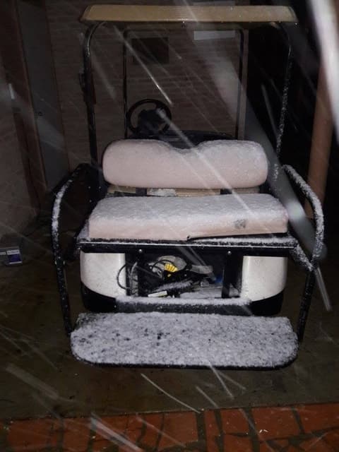 A golf cart dusted with snow, December 8, 2017.