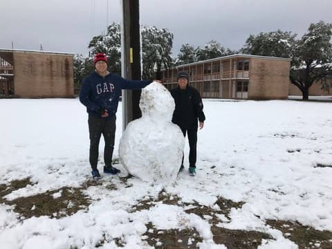 Students with the snowman they built on campus, December 8, 2017.