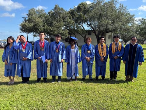 The Class of 2026 in caps and gowns on the lawn on graduation day, May 16, 2026.