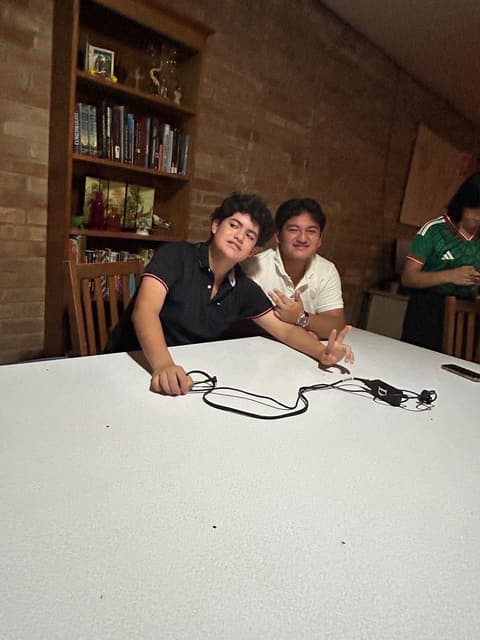 Students at a festive dinner night in the dorm lounge, with sombreros and a Mexican-flag spread, fall 2025.