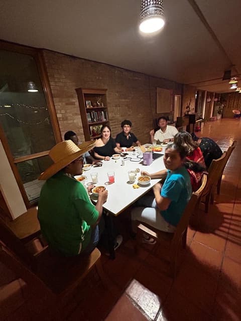 Students at a festive dinner night in the dorm lounge, with sombreros and a Mexican-flag spread, fall 2025.