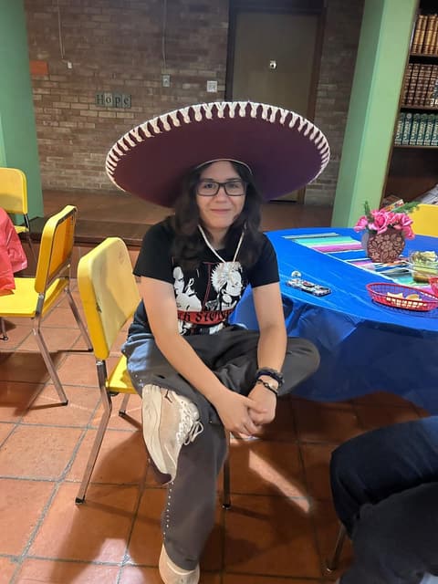 Students at a festive dinner night in the dorm lounge, with sombreros and a Mexican-flag spread, fall 2025.
