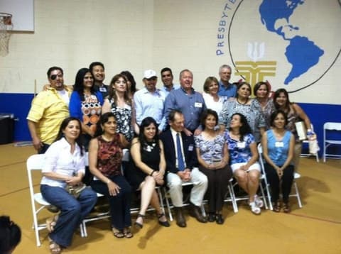 Alumni of the early 1980s in the gym, under the PPAS mural.