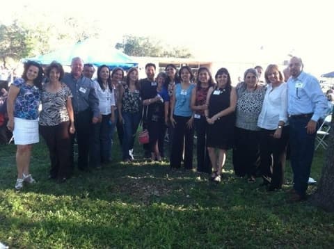 Alumni together on the lawn at a campus reunion.