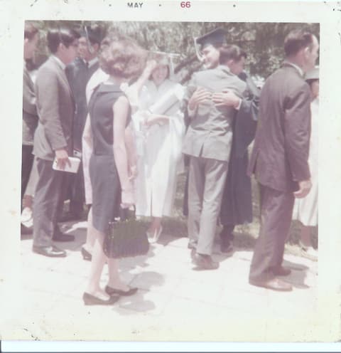 Graduation day, May 1966: the Class of 1966 congratulating one another; the poster names Martita Guzman and Albert Cortez.