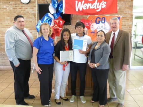 Hefzi Jimenez receives the Wendy’s High School Heisman award as the female student-athlete for all of Texas, with nominee Junsang You, Athletic Director Reili Cantu, Principal Ellie Perez and Kingsville Mayor Sam Fugate.