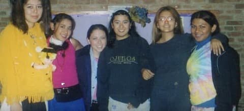 Six friends from the class that graduated in 2003, posing together in a dorm.