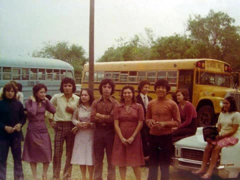 Students by the yellow school buses, late 1970s; a classmate remembers Lamar Peña.