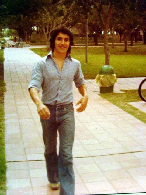 Strolling down the campus walkway in bell-bottoms.
