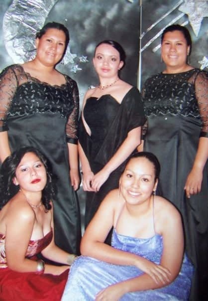 Five friends in formal gowns at a banquet.