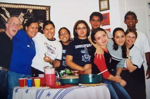 Students with a staff member at a party in the dorm; a commenter remembers Mr. Davis taking them to Dairy Queen.