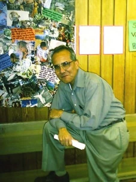 Mr. Roberto Moreno by a bulletin board in his classroom; former students call him ‘a great teacher’.