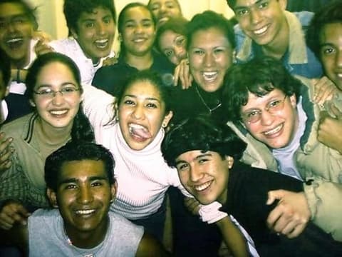 A crowd of laughing students squeezed into one frame.