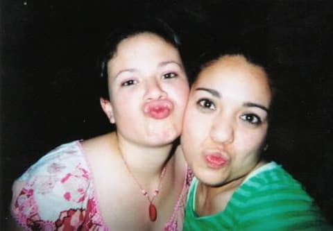 Priscilla Solis and a friend making kissing faces for the camera.