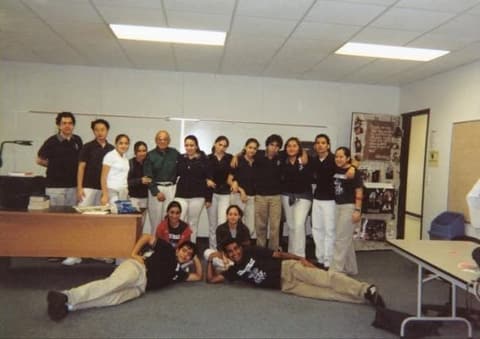 Mr. Leitos’s class, 2004, posing around the teacher’s desk.