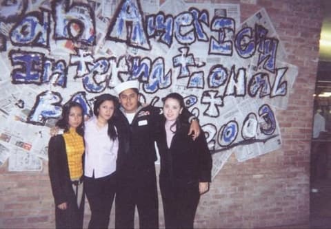At the International Banquet 2003, in front of the newspaper-mural sign.