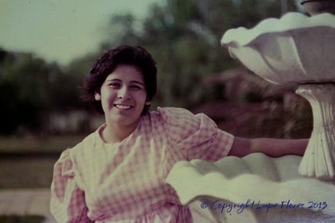 A student by a fountain, the second of the two portraits of Grace Arcos and Lamar Pena.