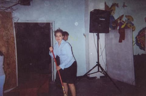 Sweeping up after a fall formal in the event hall.