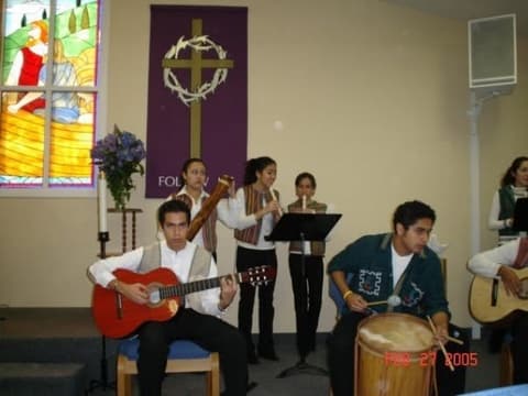 Students play guitar, flute and drum at a chapel service, February 2005.