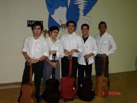 Five guitarists in white shirts under the Eagles mural, mid-2000s.