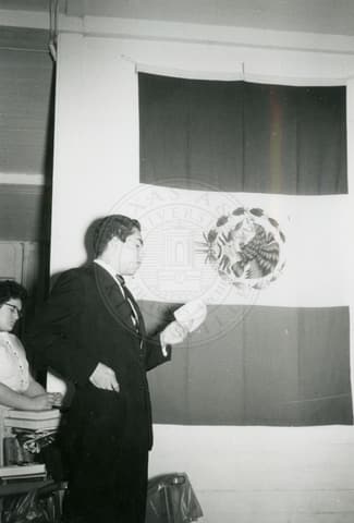 Student next to Mexican Flag.