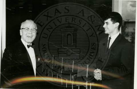 Professor and student wearing tuxedos.