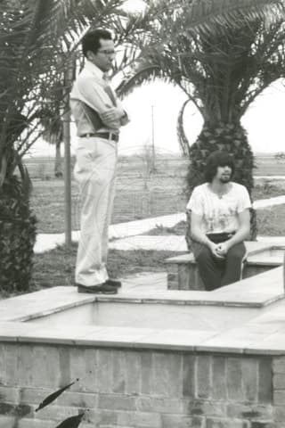 Student with professor outdoors.