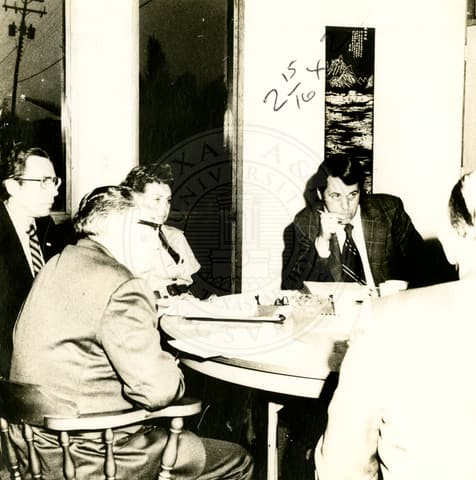 Visitors and men in school.