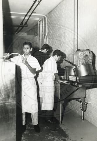 Work Program. Three boys working in the kitchen.