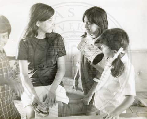 Students. Four girls sitting and talking.